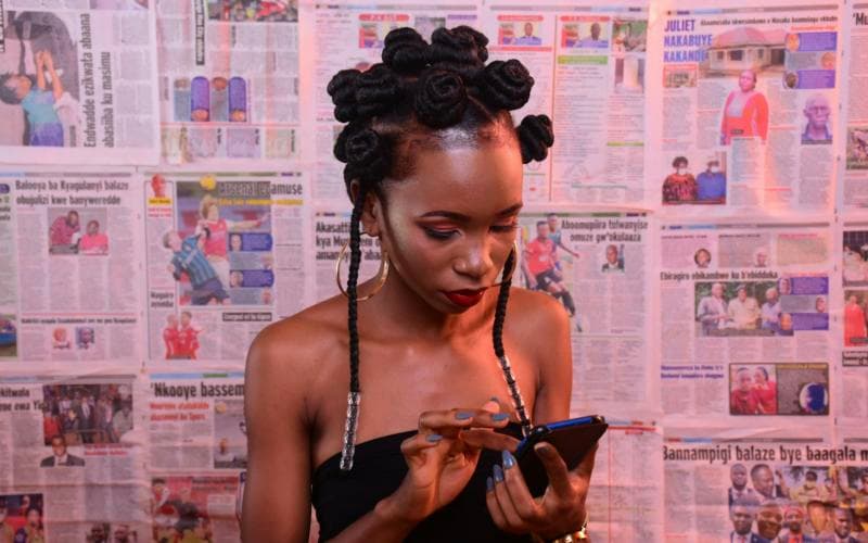 A young woman reading on her phone