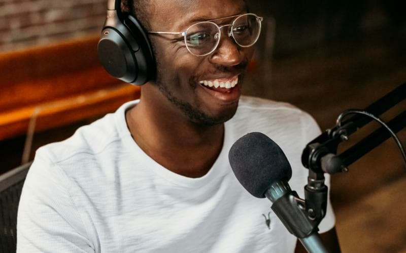 A creator recording with headphones and a microphone