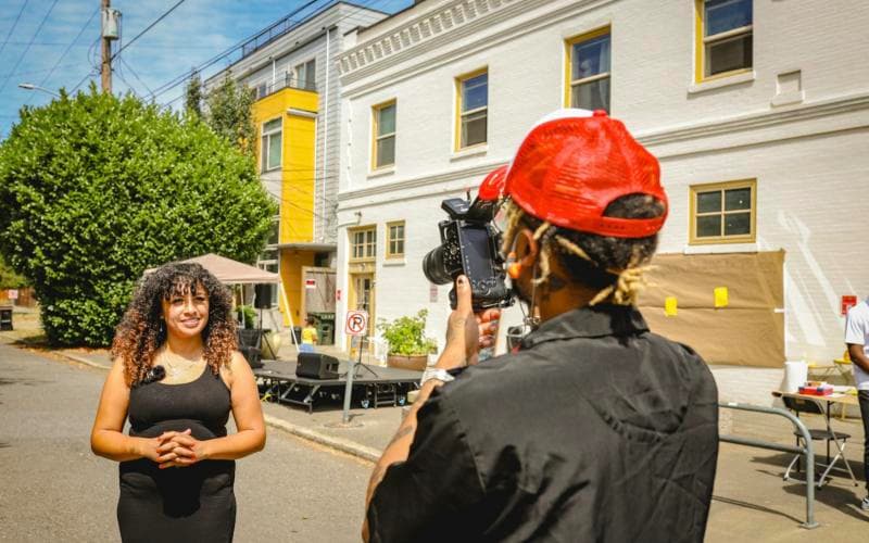A creator being filmed on the street