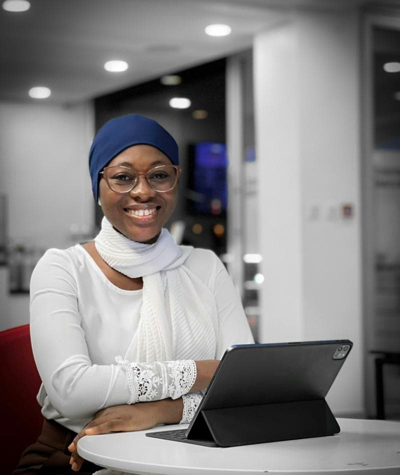 A business owner smiling while using a tablet