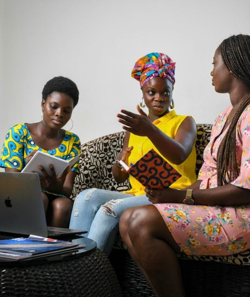 Two women discussing work over a laptop