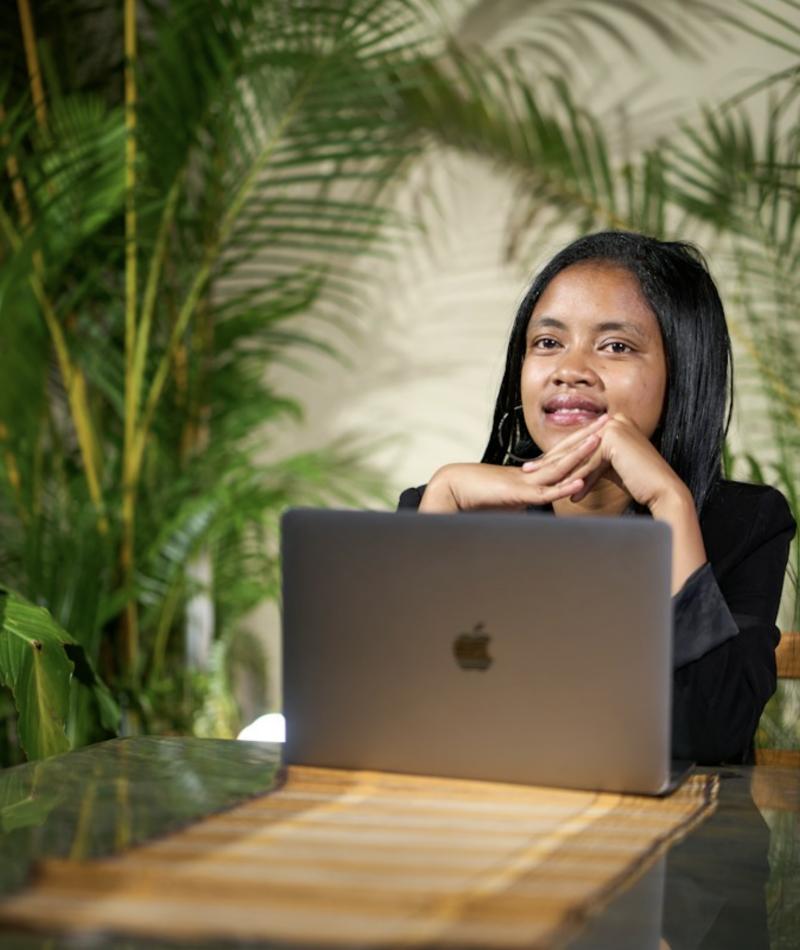 A creator working at her laptop