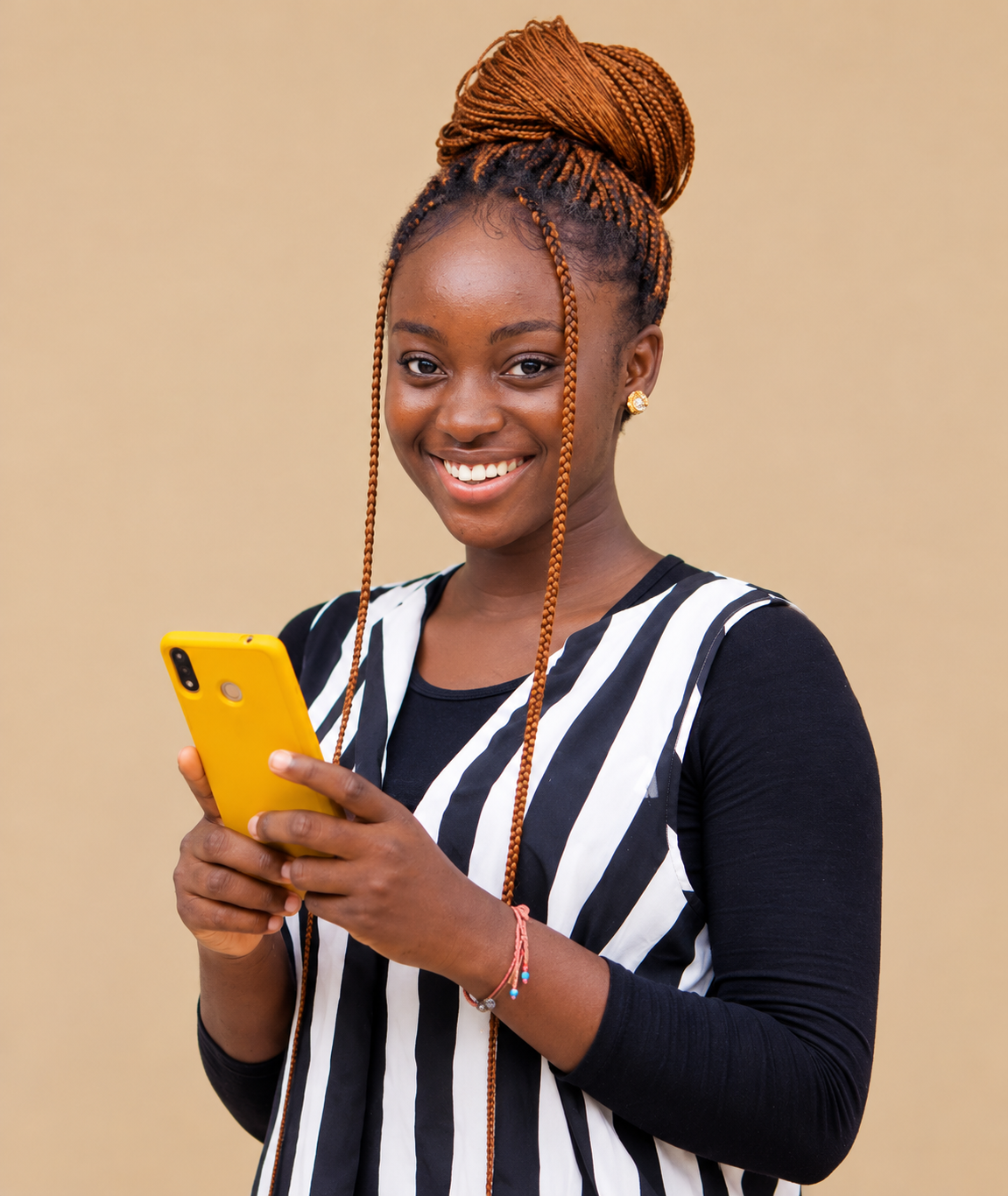 Creator smiling while using a yellow smartphone